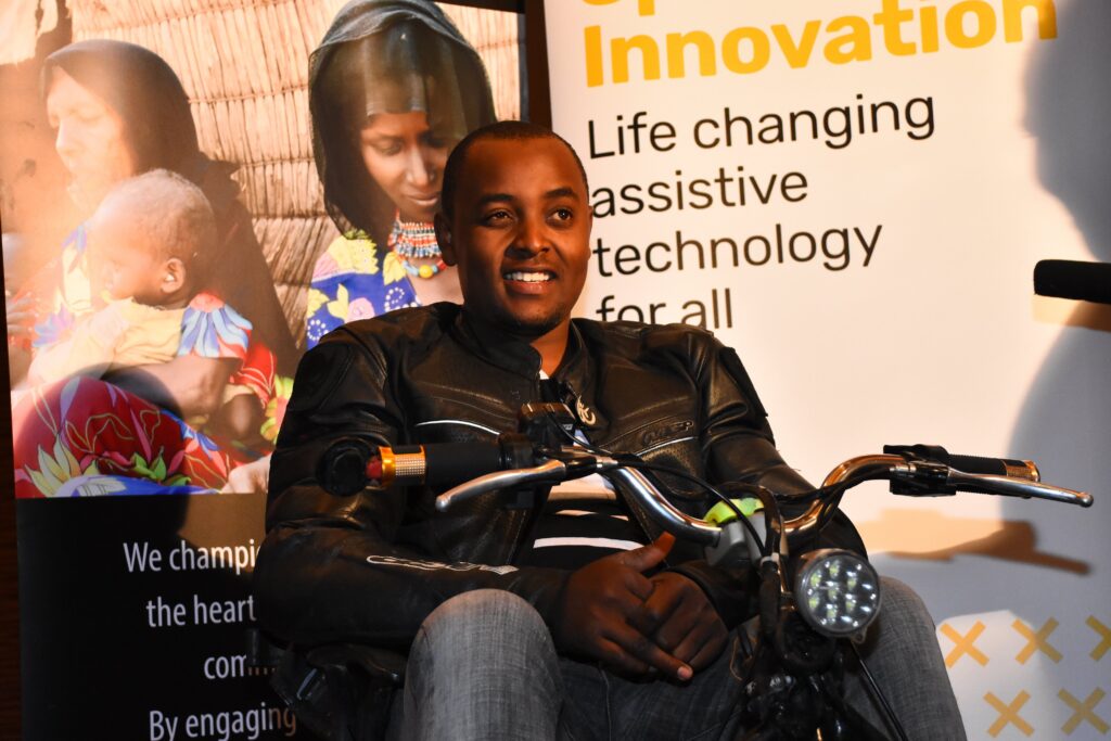 Lincoln Wamae is shown sitting on one of his custom made wheelchairs.