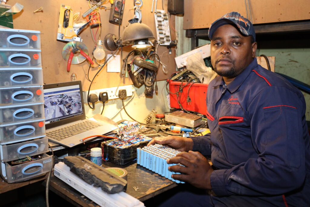 Lincon seated at his workstation in Nairobi.
