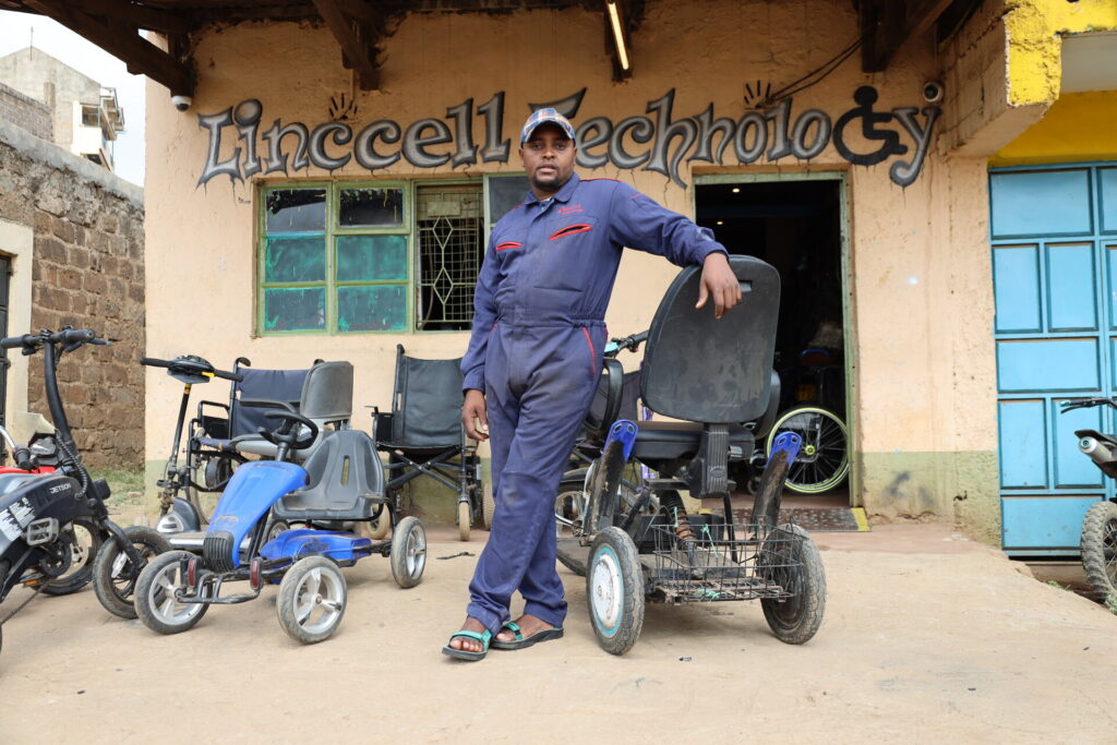 Lincon Wamae standing outside his workshop in Kenya
